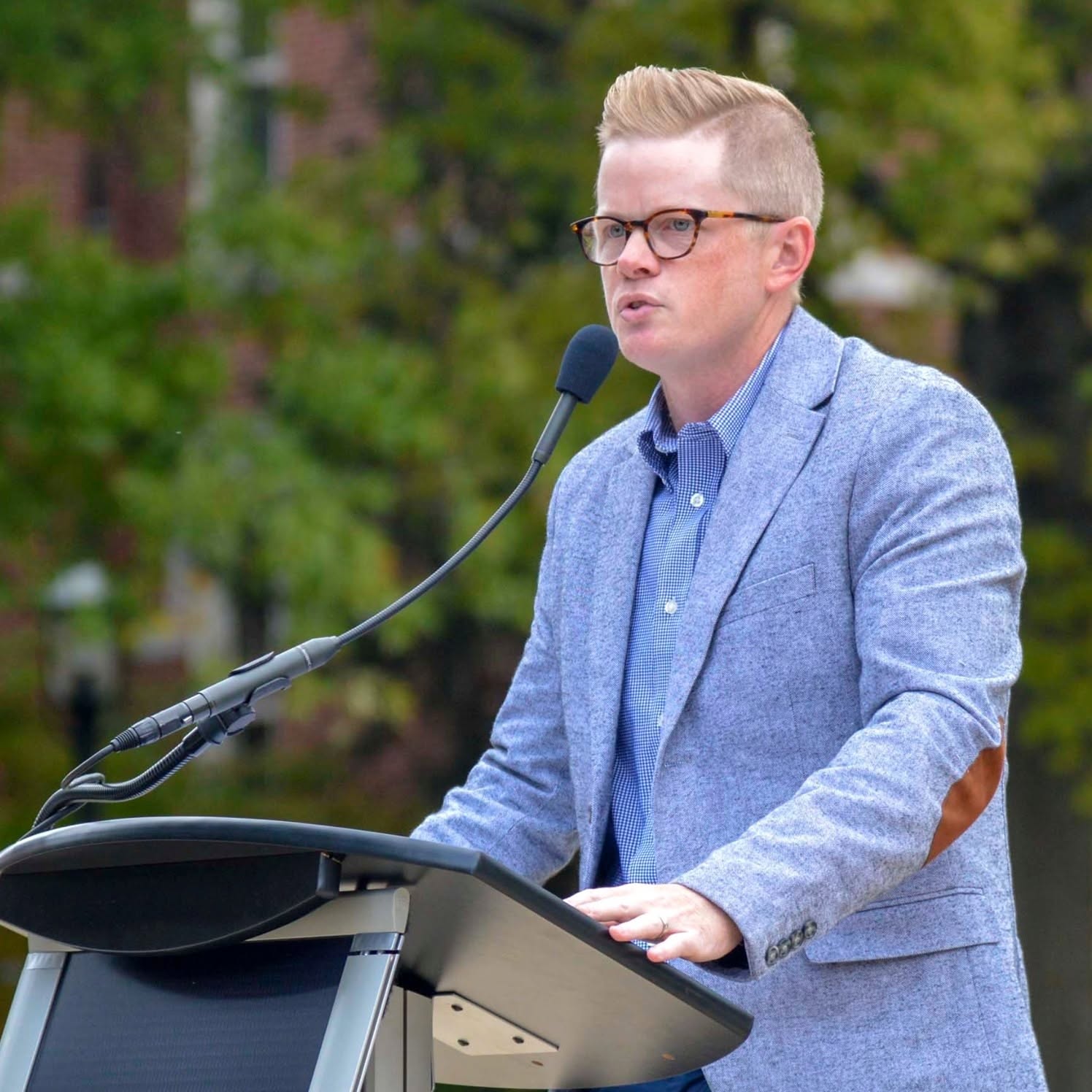 Caleb Rowden speaking at an outdoor podium
